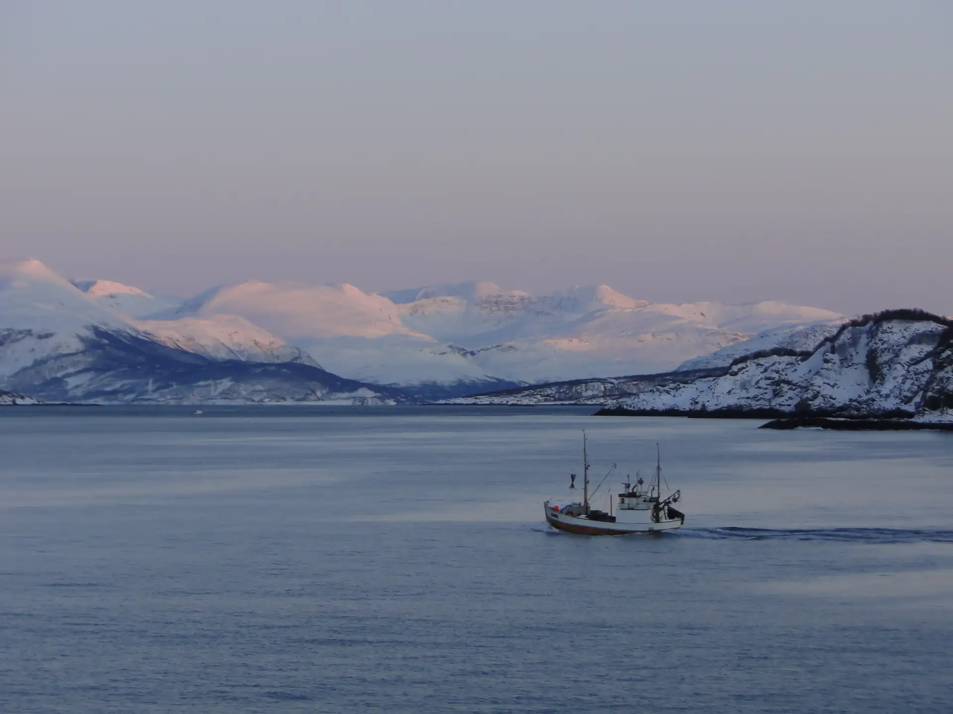 A fishing boat sailing through Skjervøy, Norway