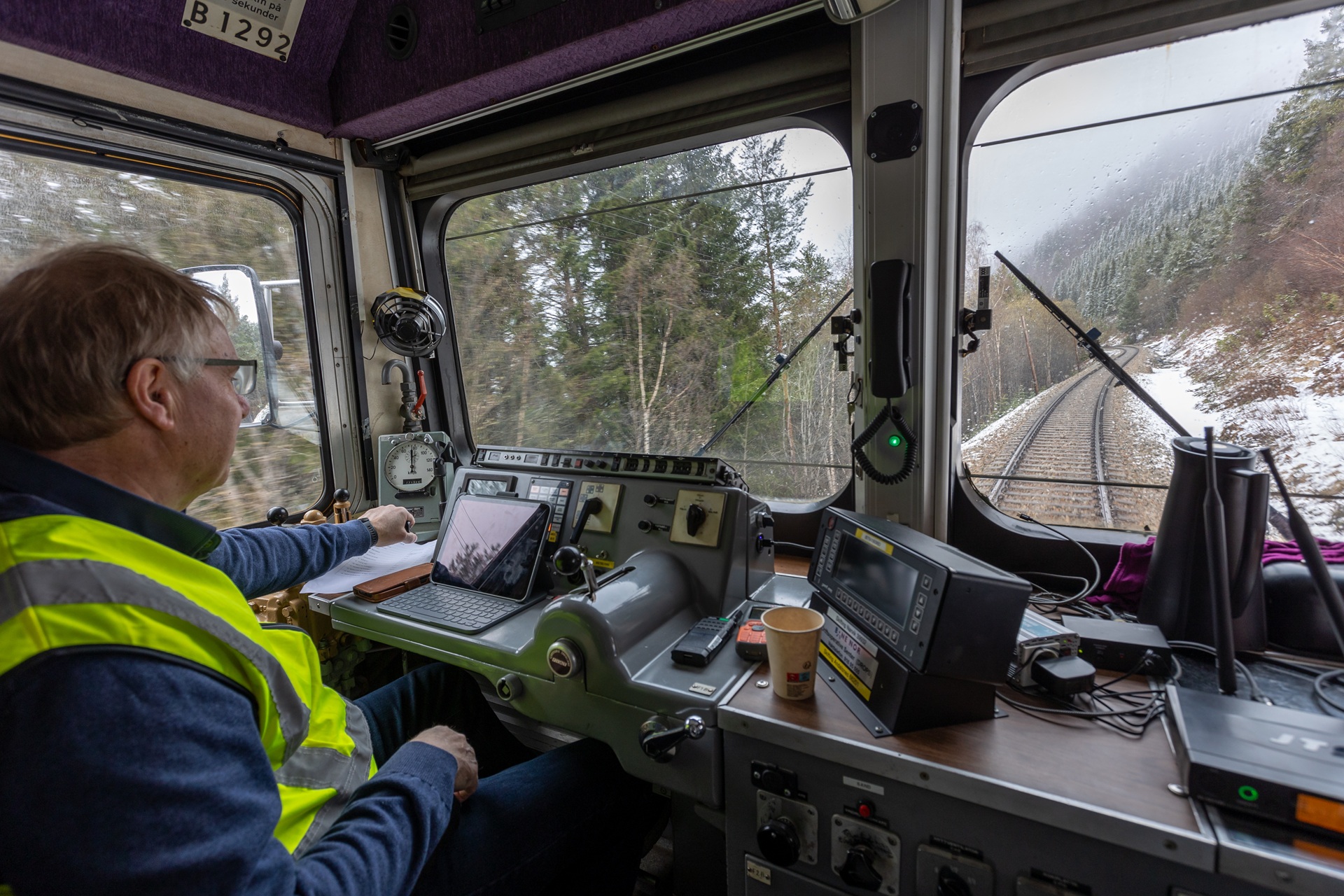 conductor-golden-train-snowy-andalsnes-norway
