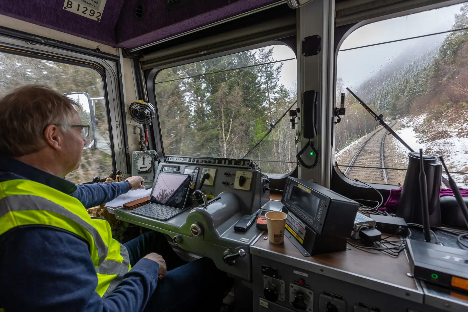 conductor-golden-train-snowy-andalsnes-norway