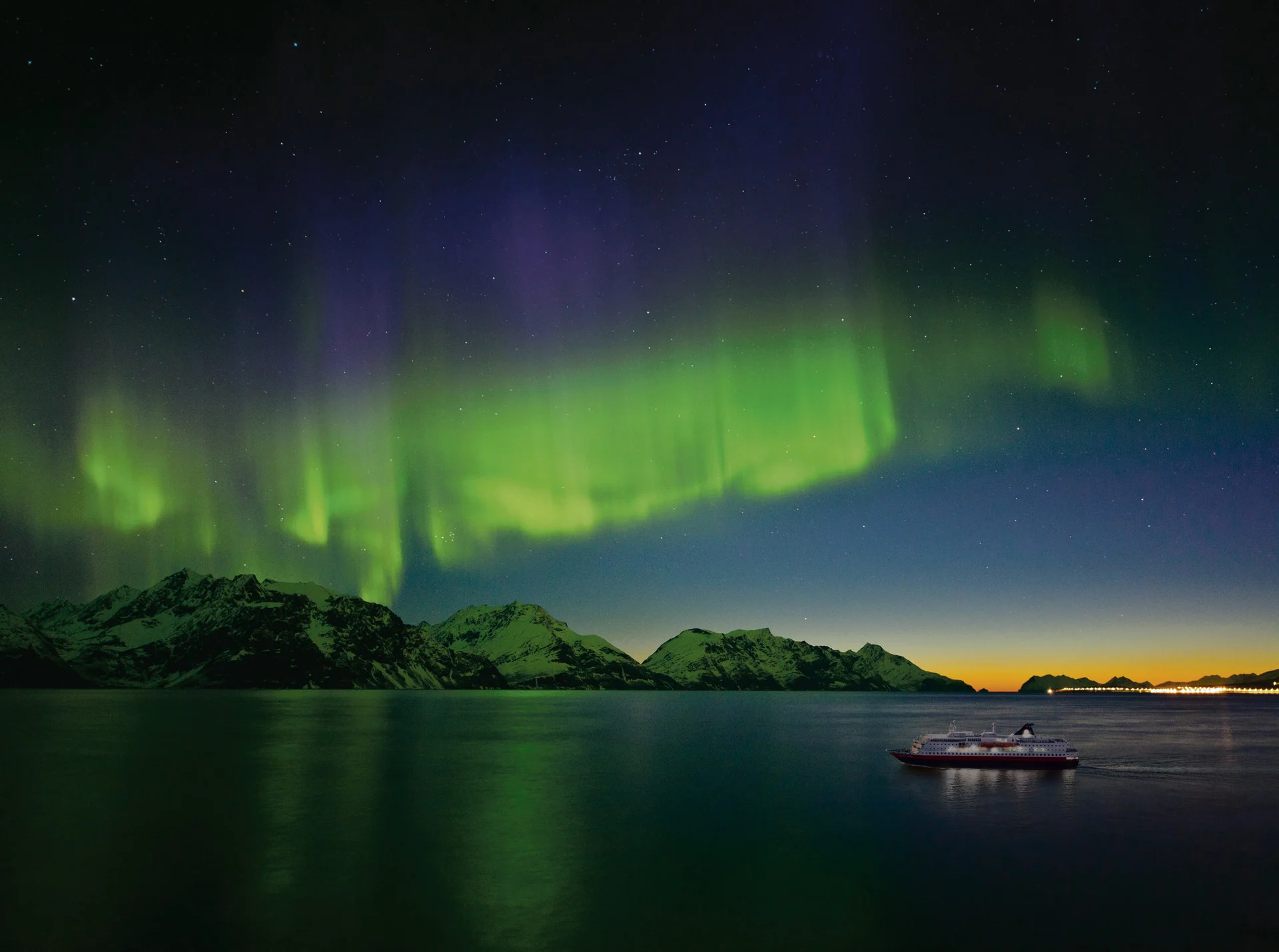 A Hurtigruten ship under the Northern Lights