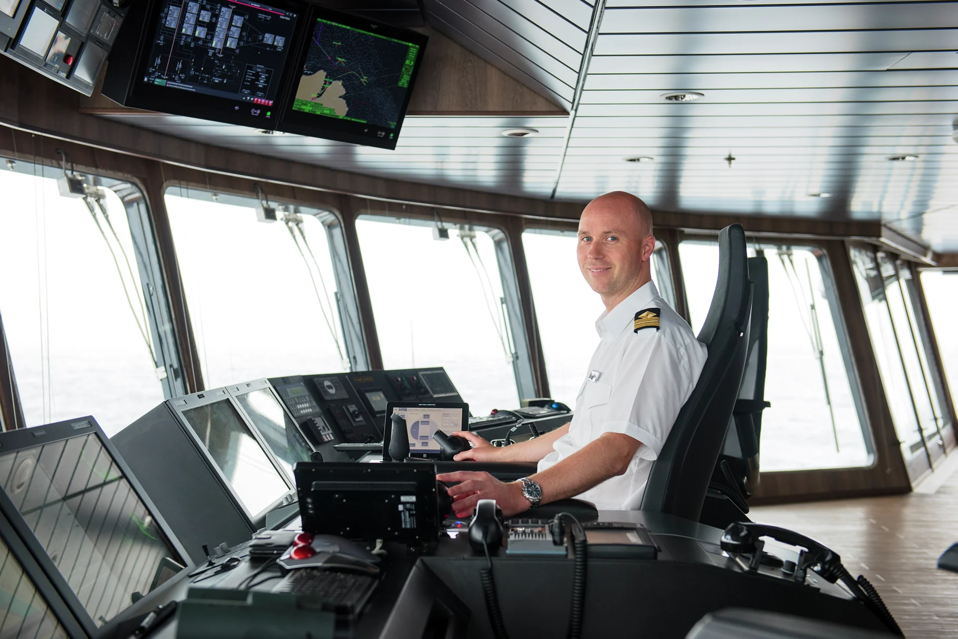 The Captain on the bridge on board a Hurtigruten ship
