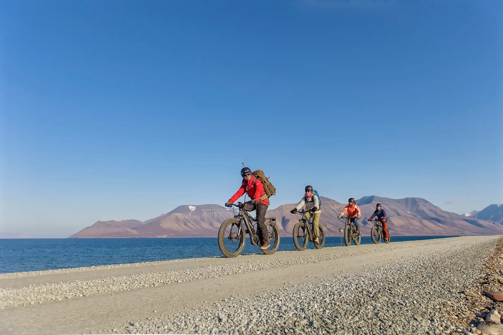 people-riding-electric-bikes-sunny-day-longyearbyen-svalbard-norway-agurtxane-concellon