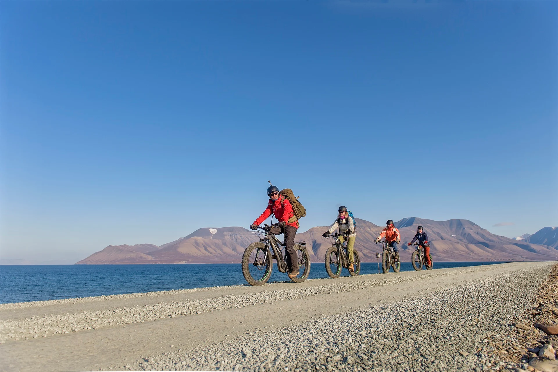 people-riding-electric-bikes-sunny-day-longyearbyen-svalbard-norway-agurtxane-concellon