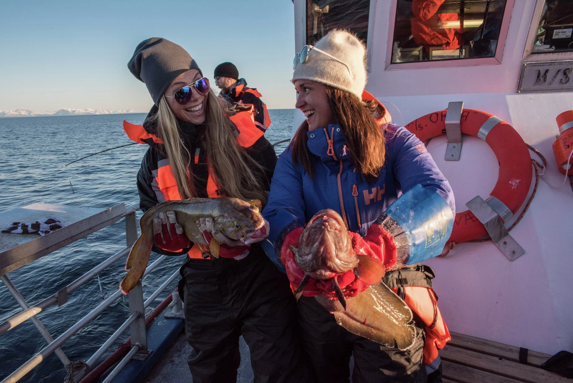 Two women with their catch on a fishing trip in the Lofoten Islands