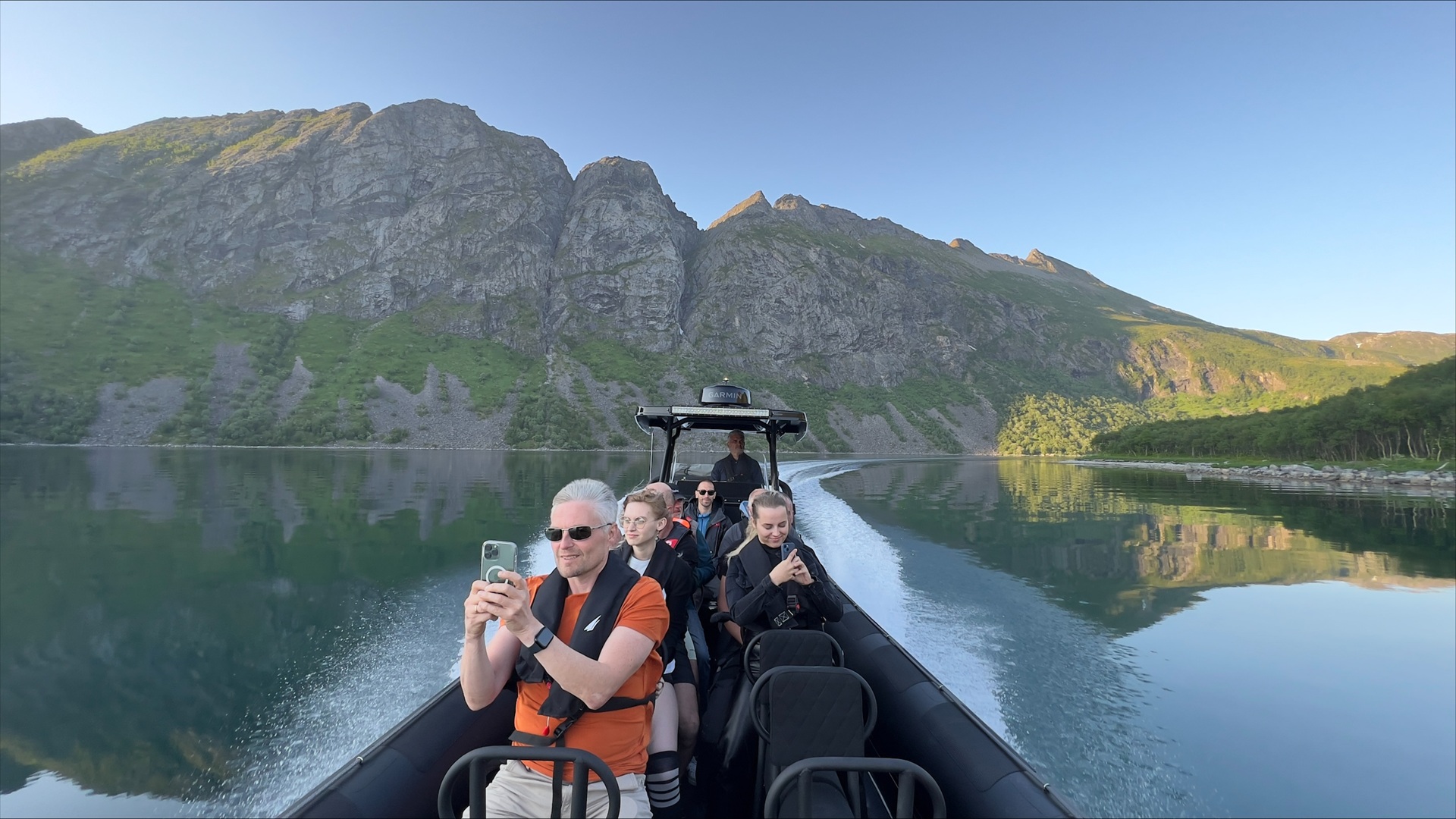 people-phones-rib-boat-fjord-senja-norway