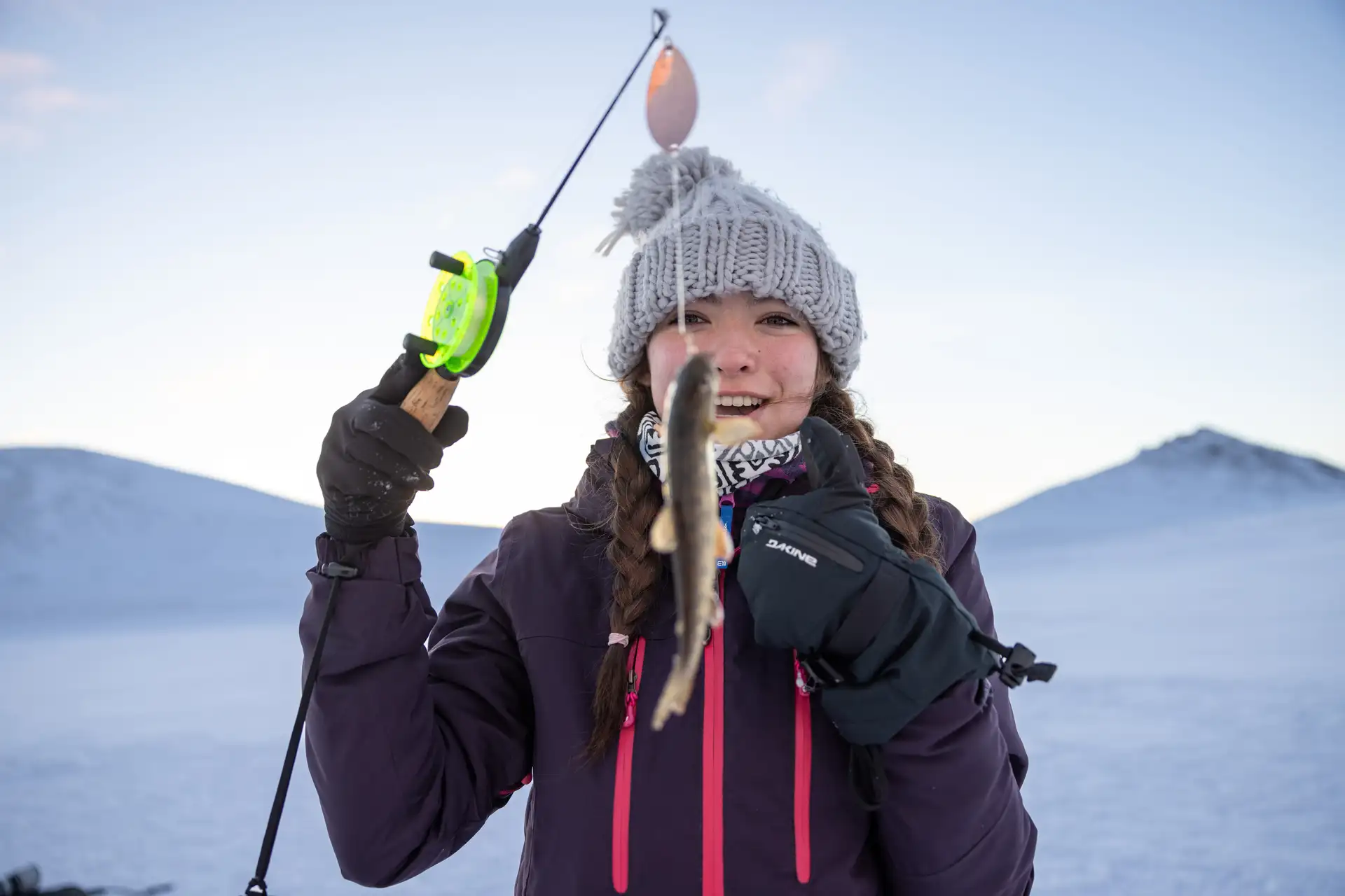 A person arctic ice fishing in Norway – Espen Mills