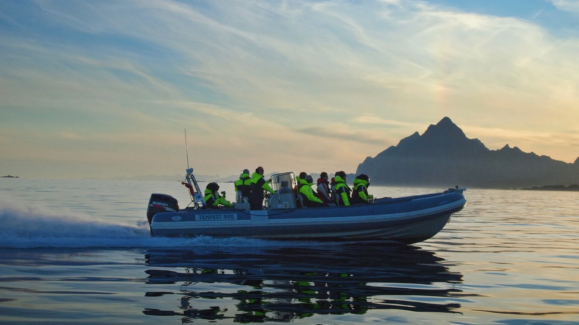 A group of tourists enjoy a RIB experience in the Lofoten Islands