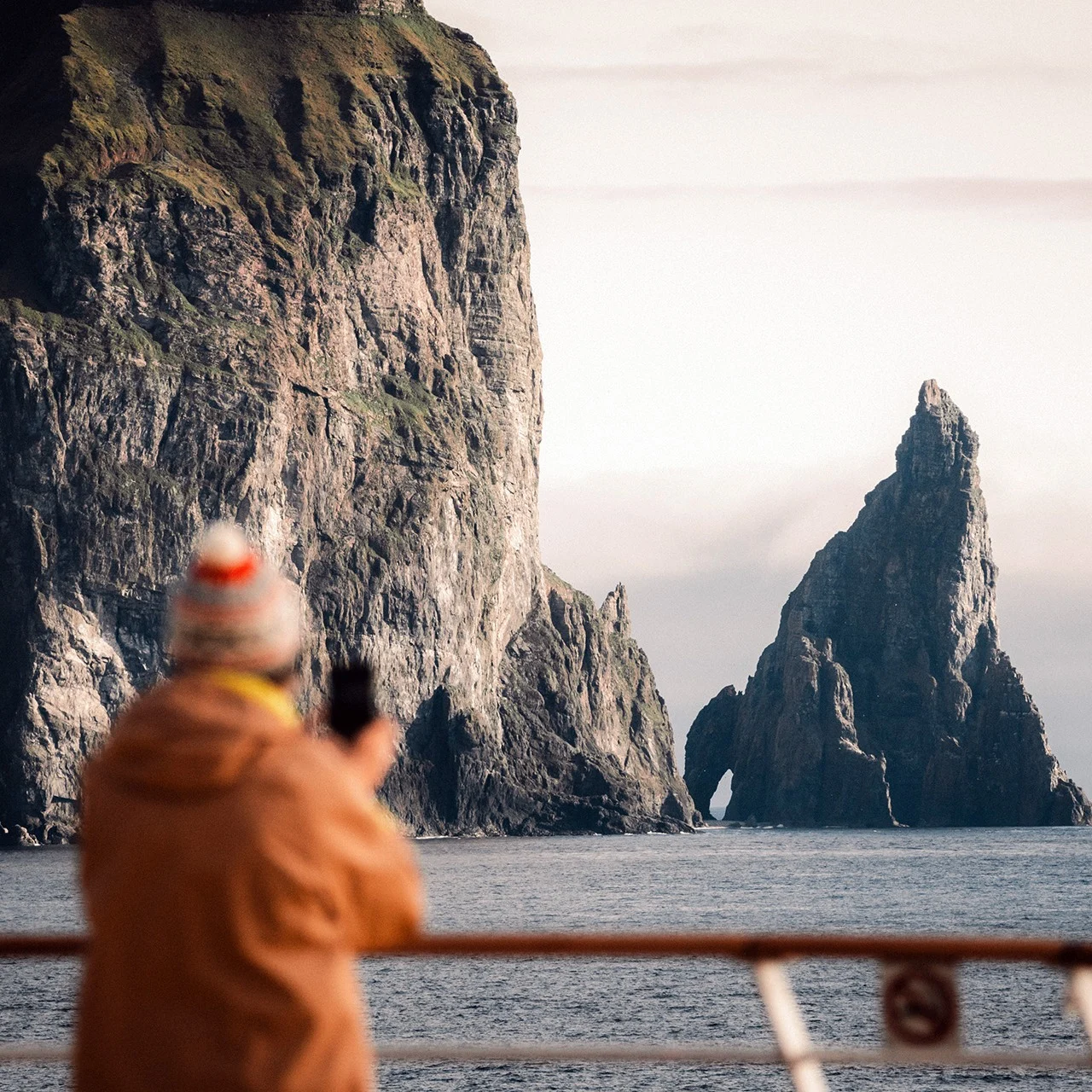 A Hurtigruten passenger looks out at Bjørnøya in Norway. Photo by: mcburneyphotography