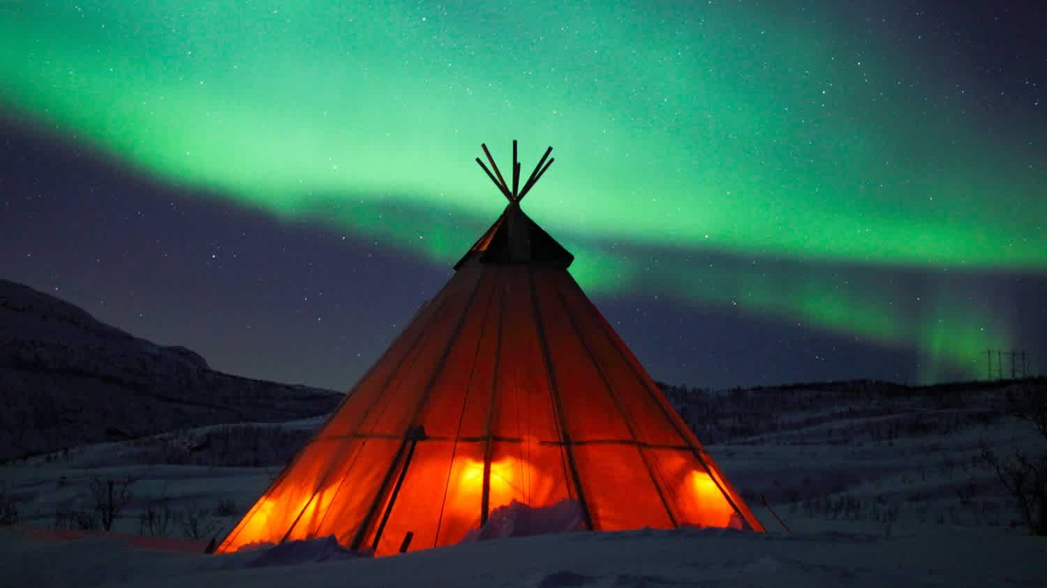 Northern Lights in the sky above a Sami tent