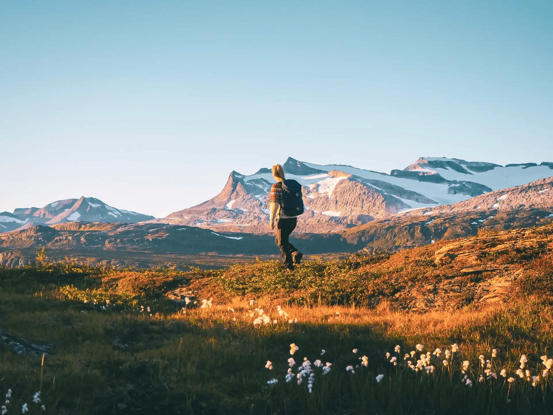 A solo traveller hiking through the mountains in Norway in autumn. Image copyright: Marte J. Åsland - Visit Helgeland - Visit Norway