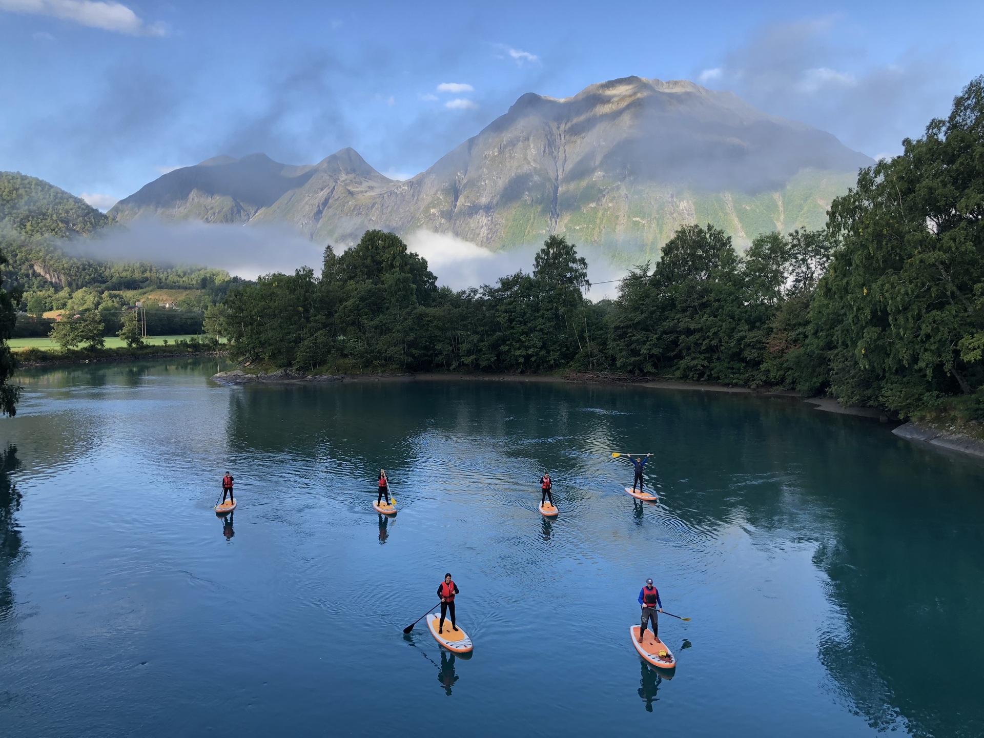 people-paddleboarding-rauma-river-romsdal-alps-andalsnes-norway-daytime-low-clouds