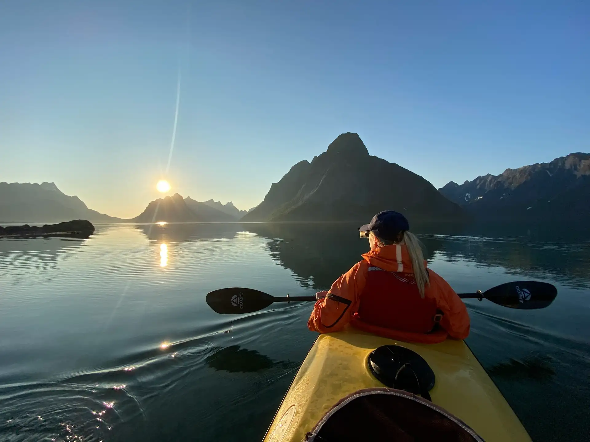 person-yellow-kayak-paddle-water-fjords-sun-horizon-reflection