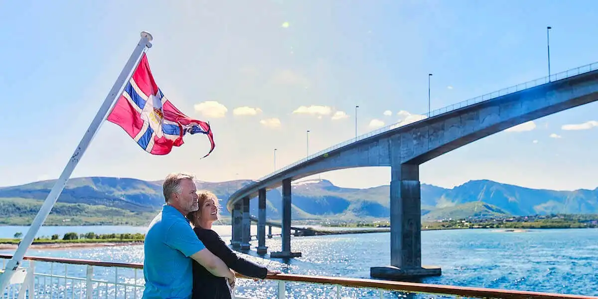 A man standing on a bridge over a body of water