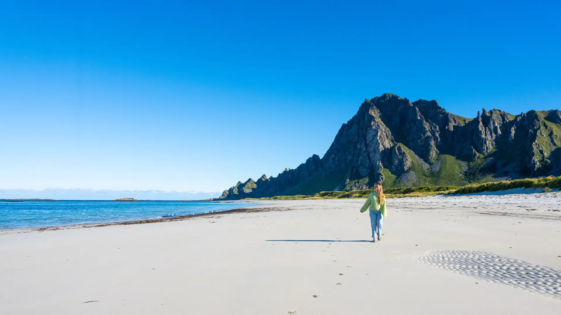 Woman hiking at Bleik beach