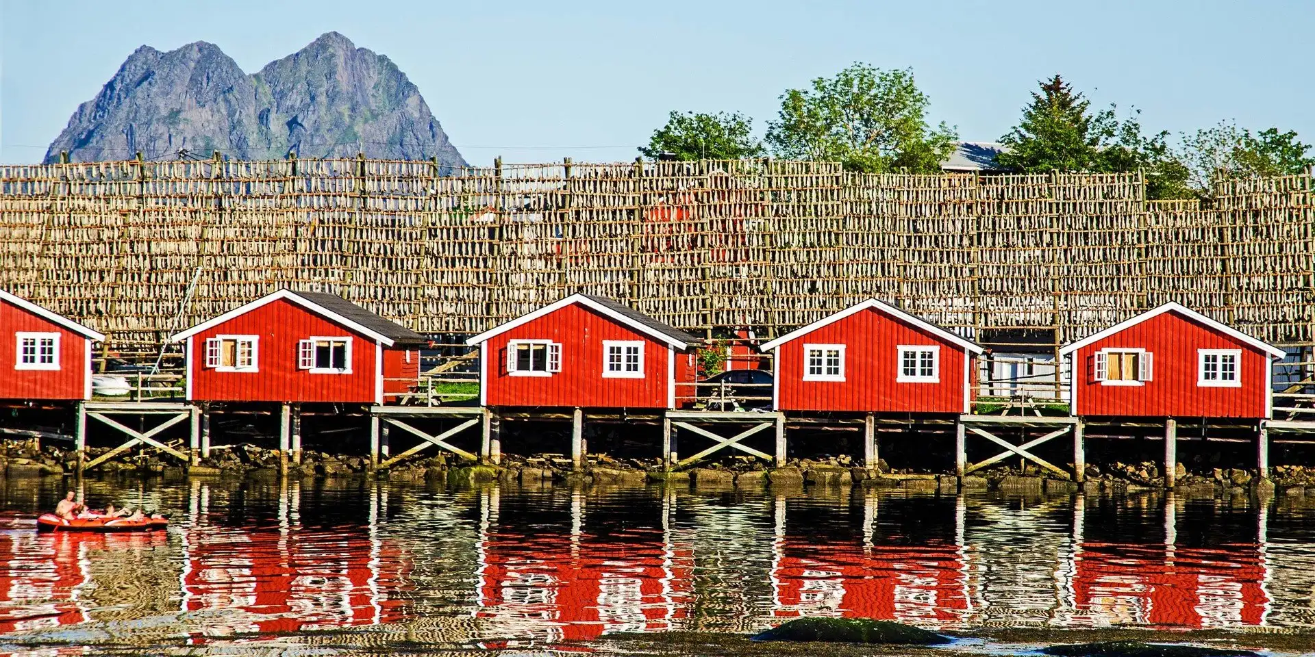 A large building with a mountain in the background