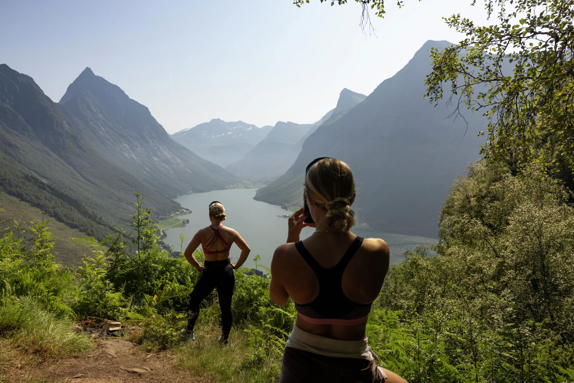 Un couple de randonneuses prenant une photo dans le Hjørundfjord 