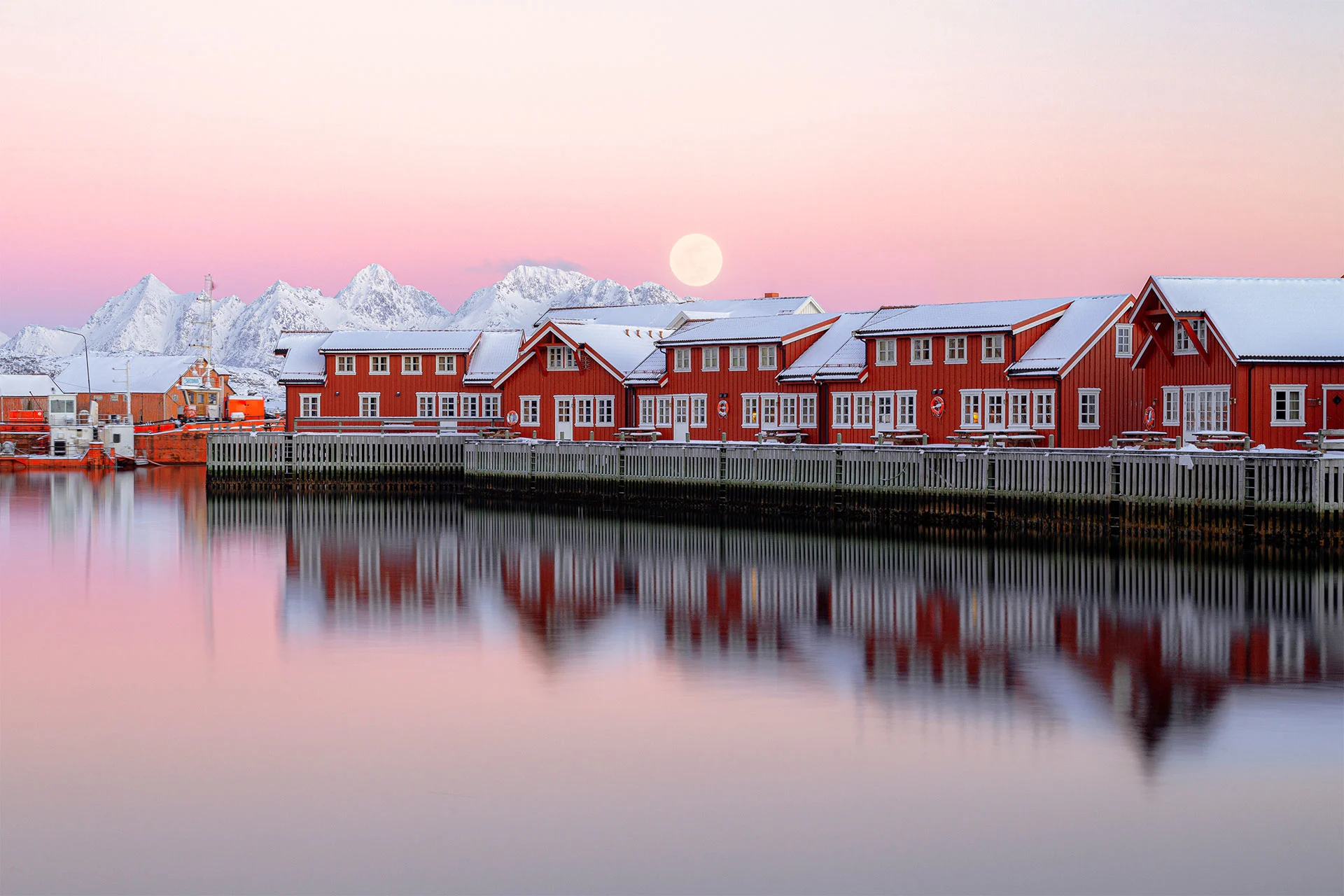 Red rorbuer reflecting in the water in the Lofoten town of Svolvær