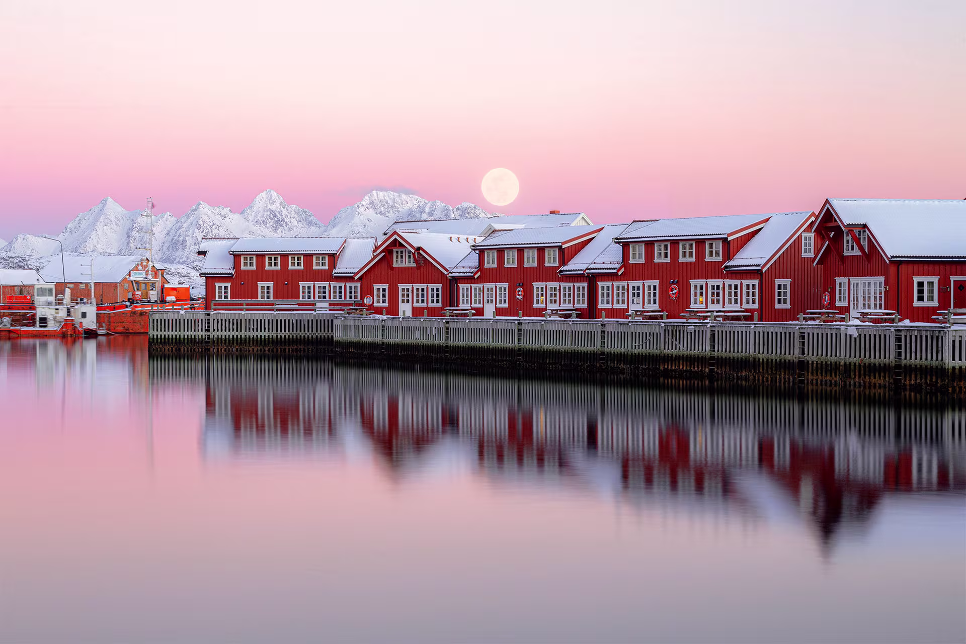 Reflections of red rorbuer in Svolvær, Lofoten's largest settlement
