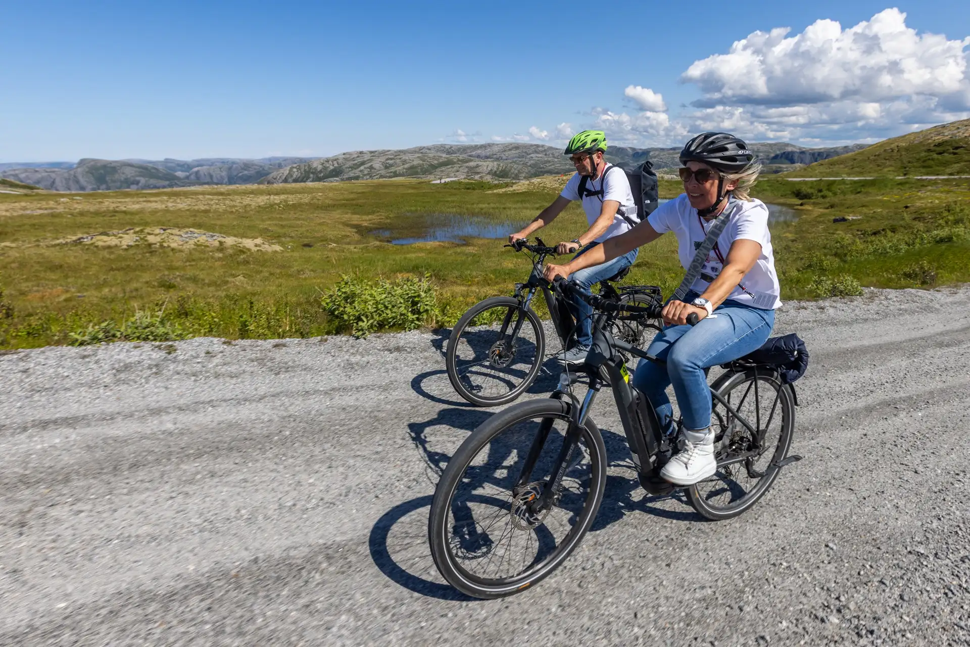 people-electric-bikes-gravel-road-blue-sky-bessaker-norway-m-afflerbach