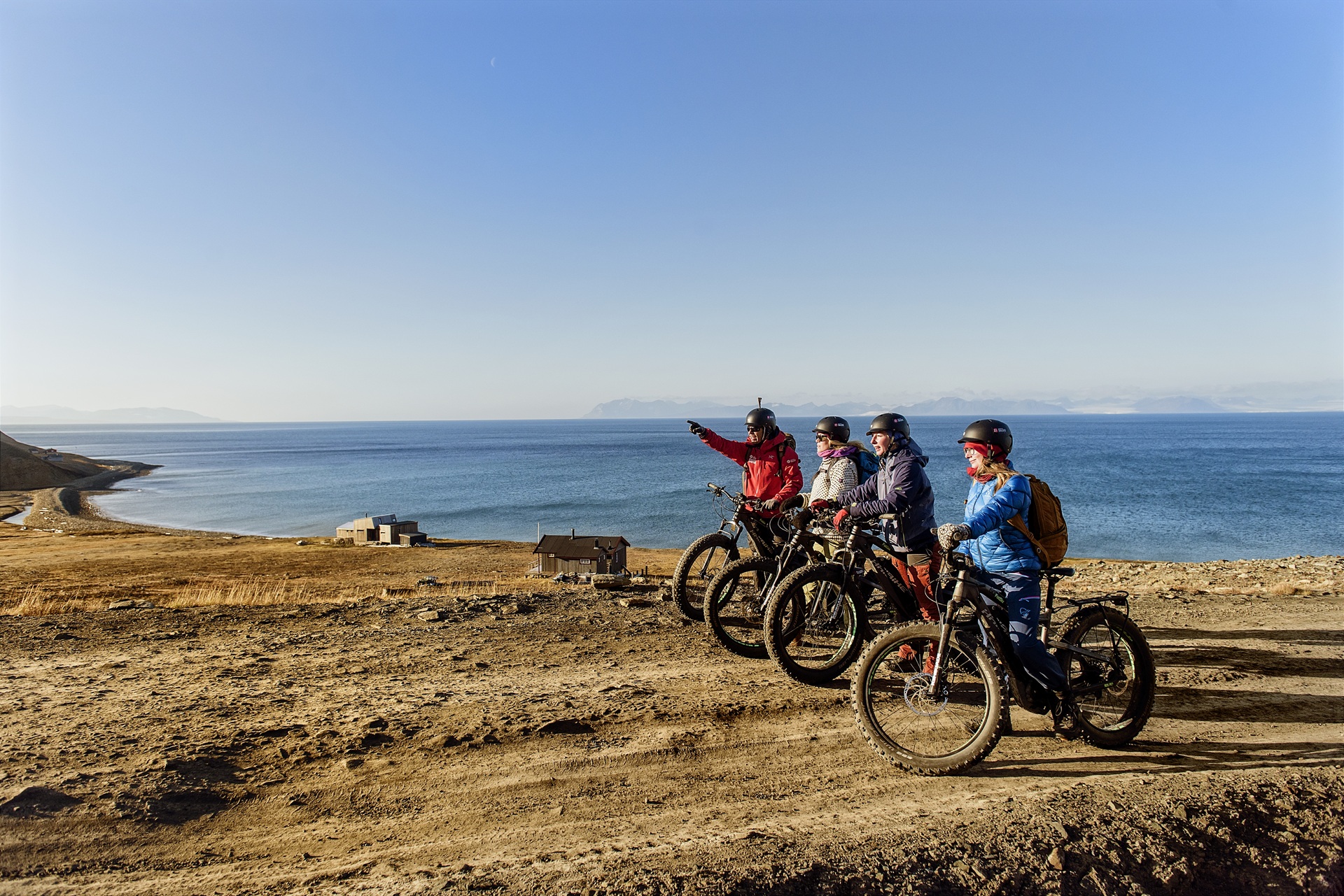people-electric-bikes-looking-into-distance-longyearbyen-svalbard-norway-agurtxane-concellon