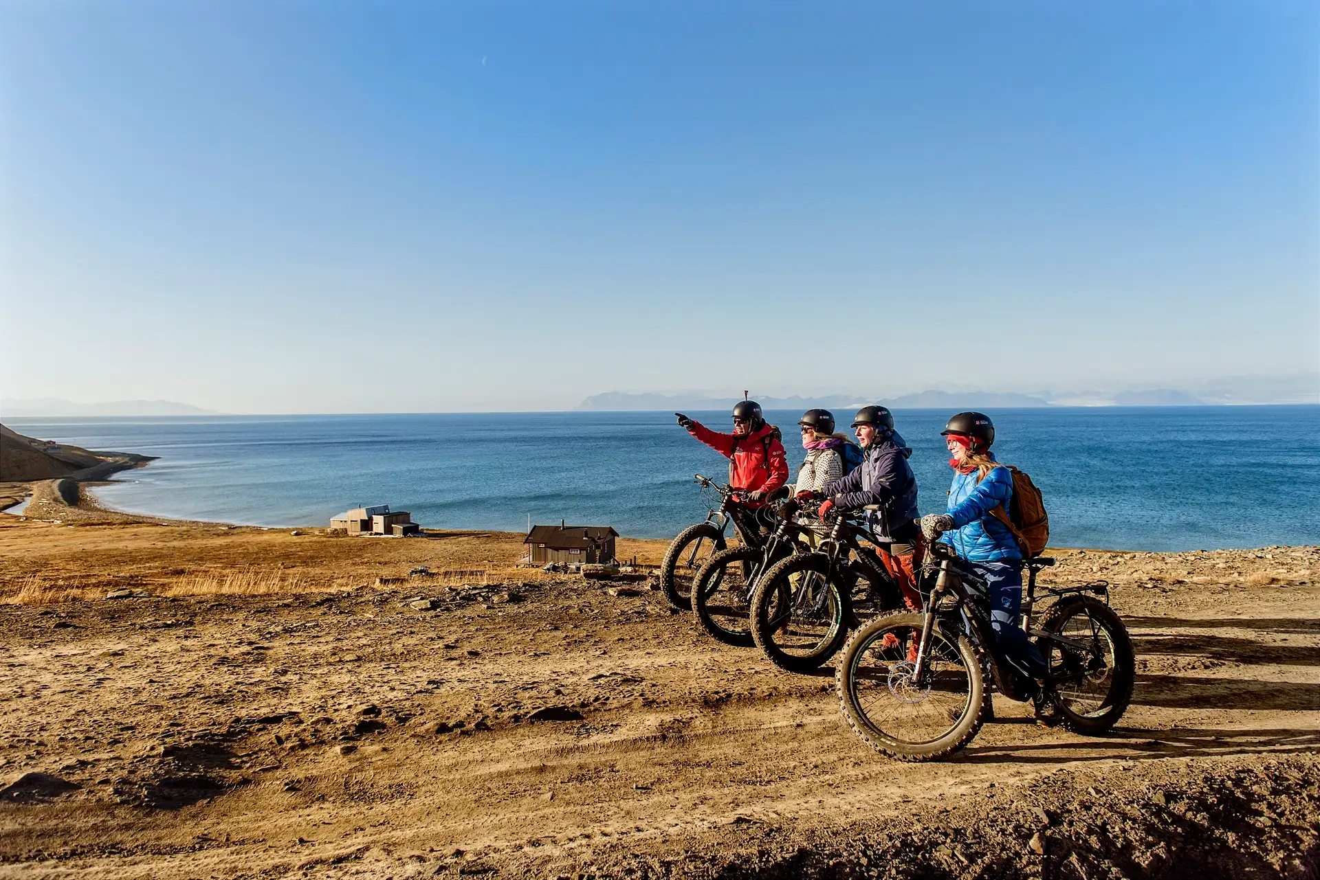 people-electric-bikes-looking-into-distance-longyearbyen-svalbard-norway-agurtxane-concellon