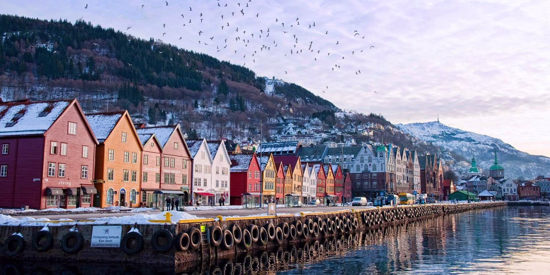 A large building with a mountain in the background