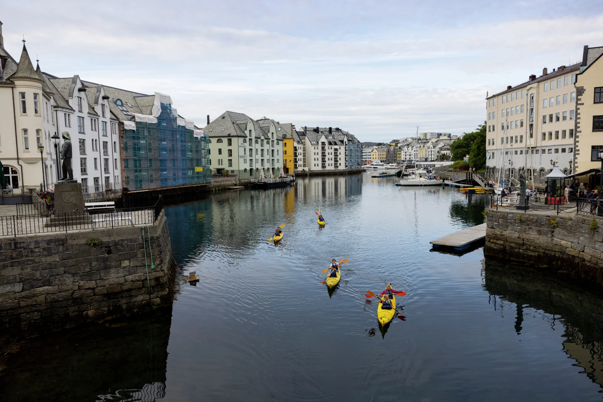 A group of kayakers exploring the canals in Alesund