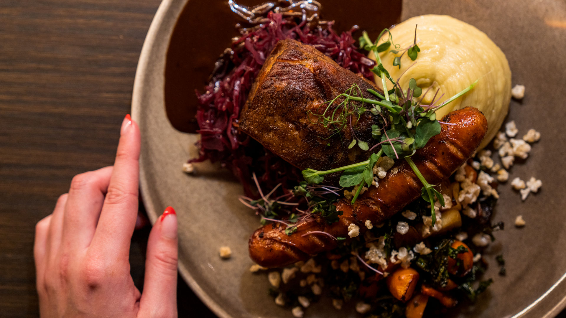 A traditional Norwegian Christmas dinner of ribbe (pork ribs) served with Christmas sausage. Image copyright: Fredrik Ahlsen - Visit Norway