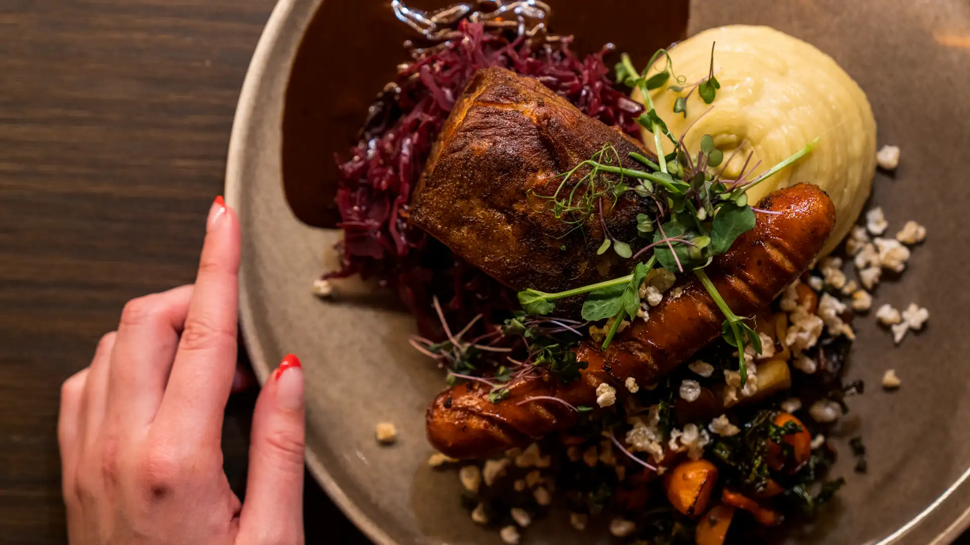 A traditional Norwegian Christmas dinner of ribbe (pork ribs) served with Christmas sausage. Image copyright: Fredrik Ahlsen - Visit Norway