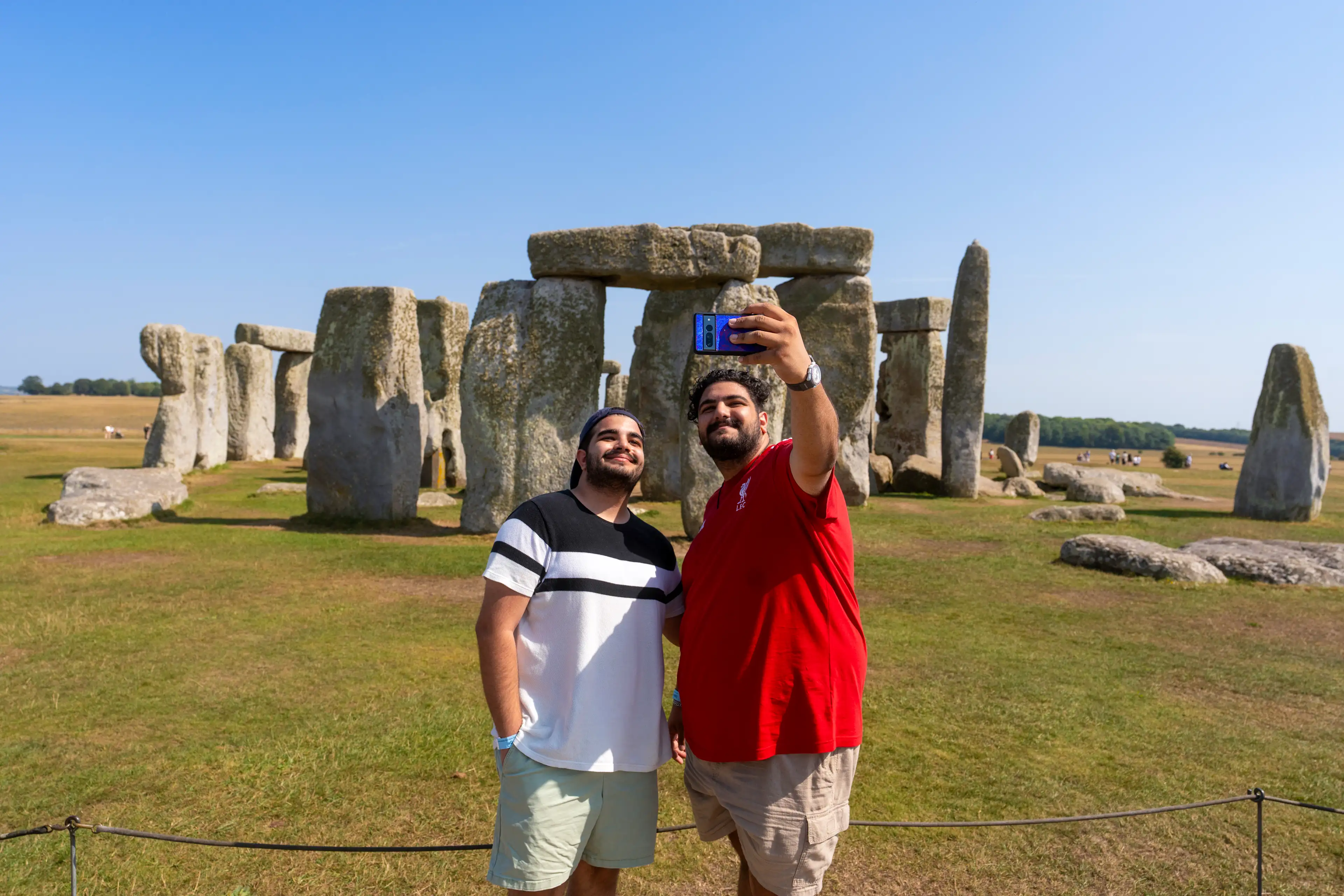 Two people taking a selfie in front of the Stonehenge