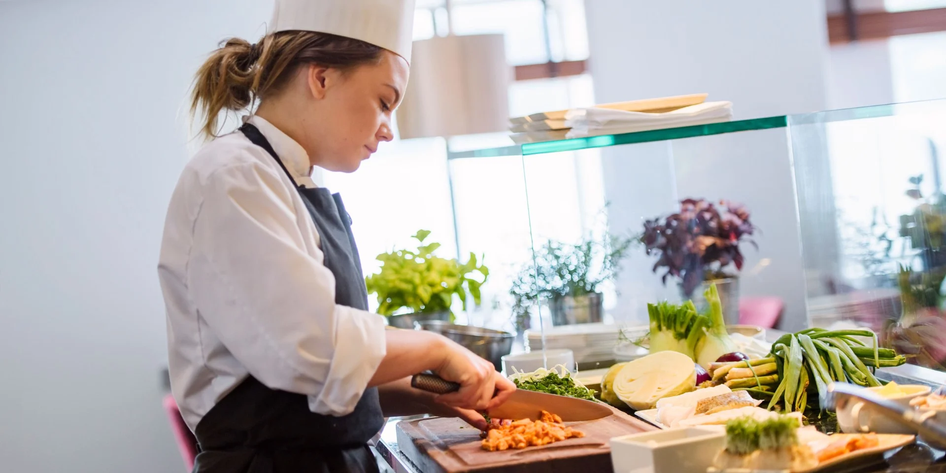 A woman preparing food in a kitchen