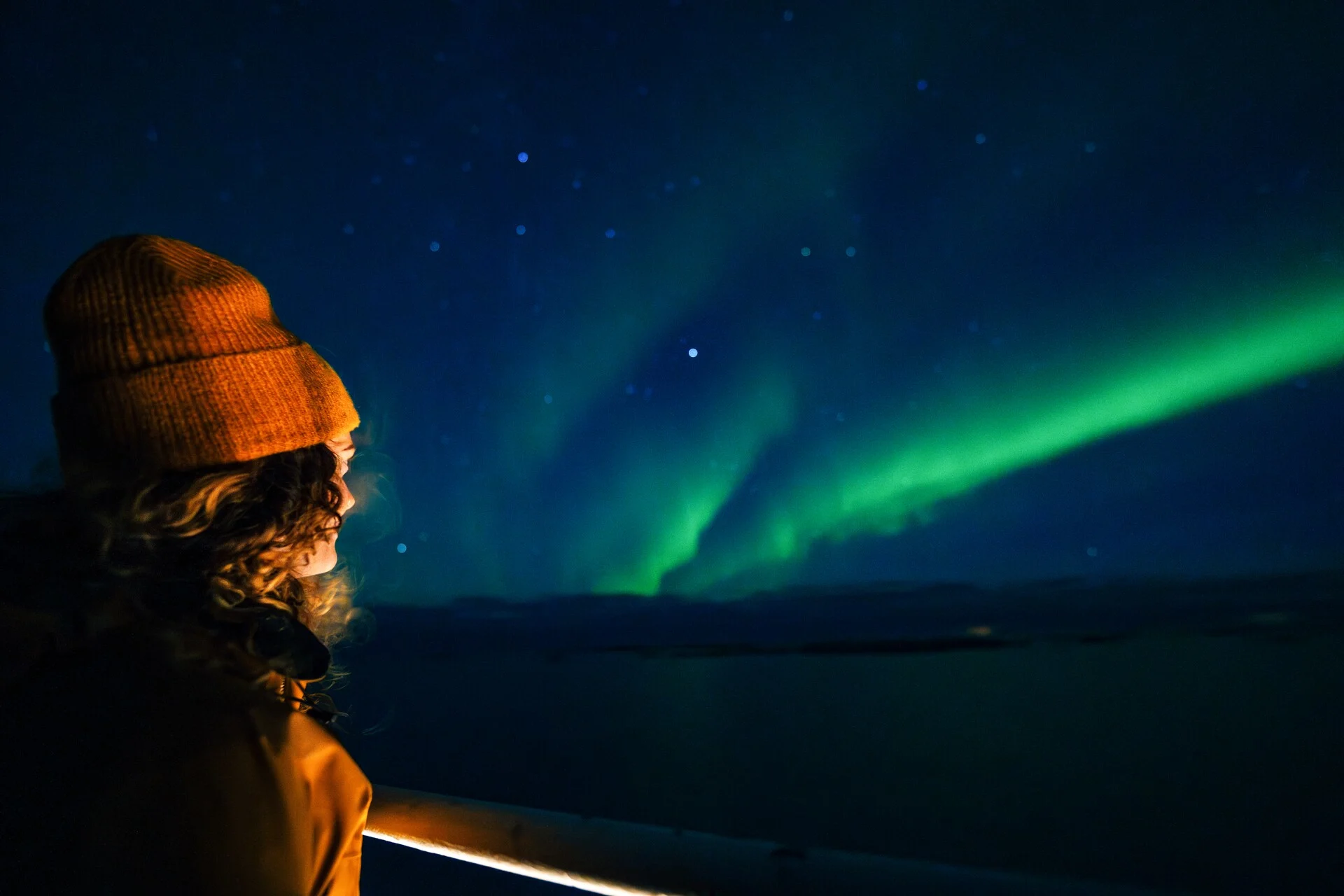 Looking at the Northern Lights from the deck of a Hurtigruten ship in Alta, northern Norway