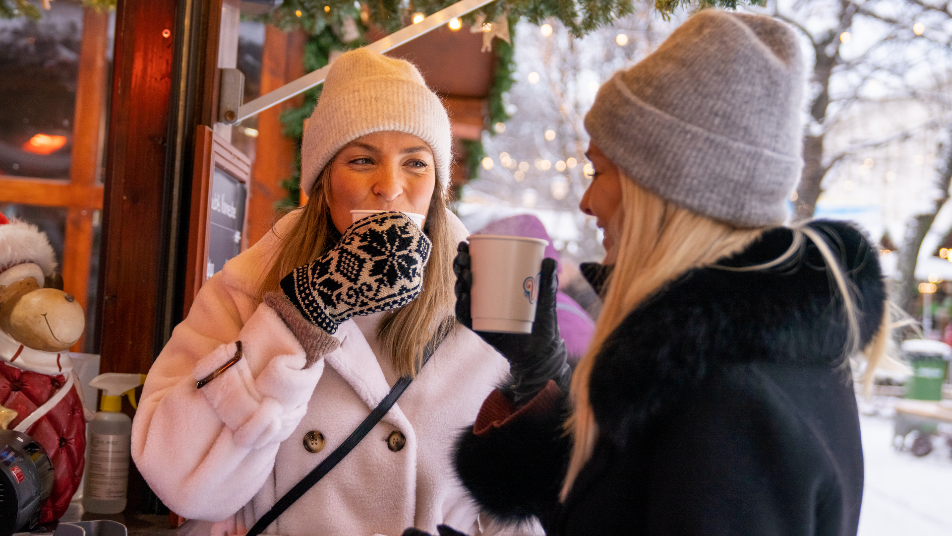 Drinking hot chocolate at a Christmas market in Trondheim, Norway. Image copyright: Fredrik Ahlsen - Maverix Media AS