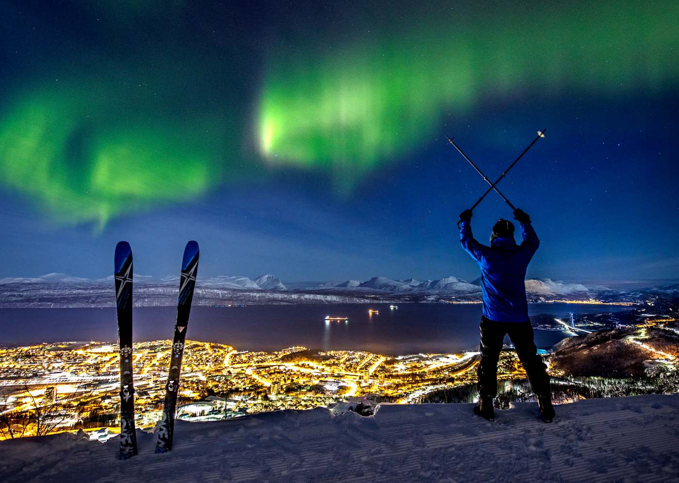 A skier stood with the Northern Lights in the sky in Narvik, Norway