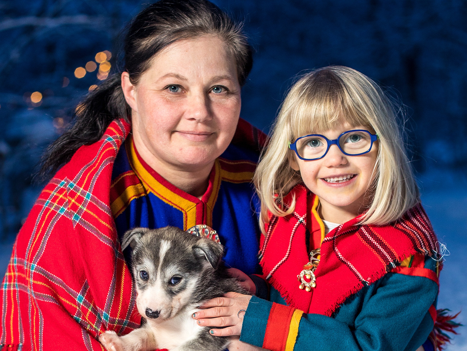 woman-young-girl-sami-clothes-smiling-husky-puppy-isogaisa
