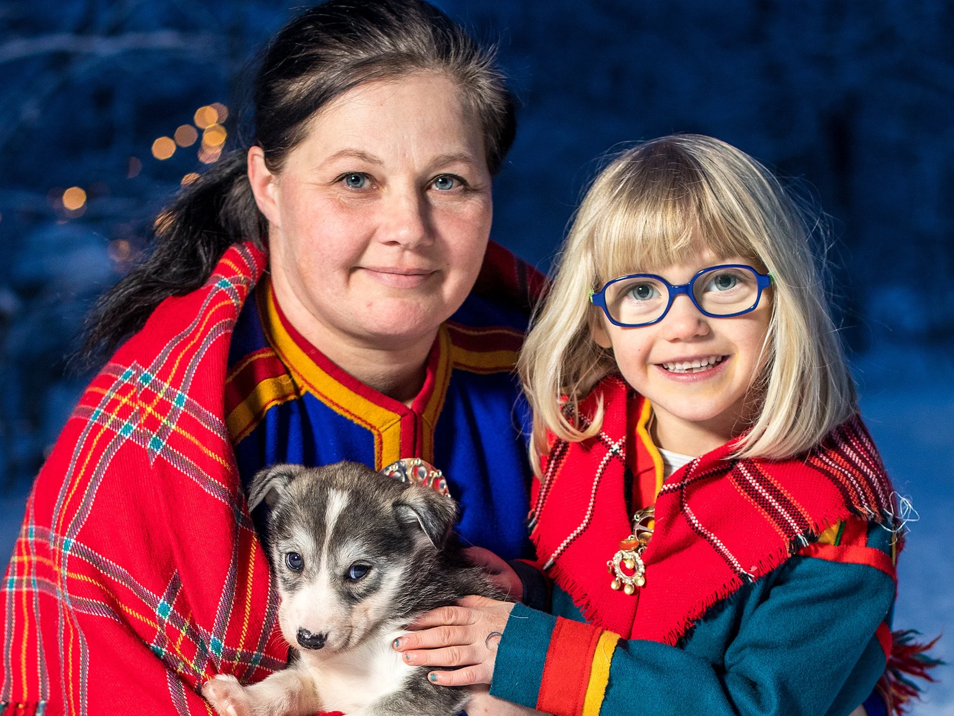 woman-young-girl-sami-clothes-smiling-husky-puppy-isogaisa