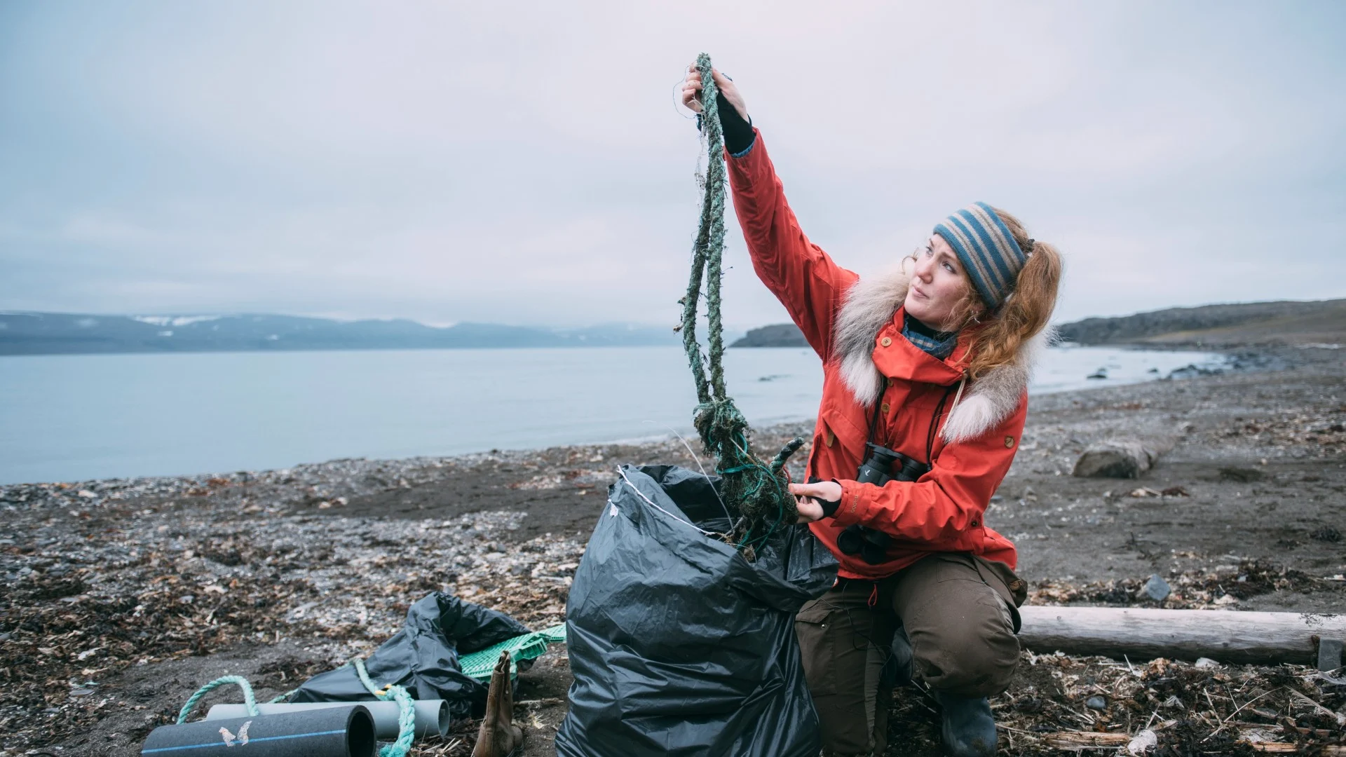 Biologist and expedition leader, Helga Bårdsdatter Kristiansen is at a beach filled with garbage, cleaning the beach