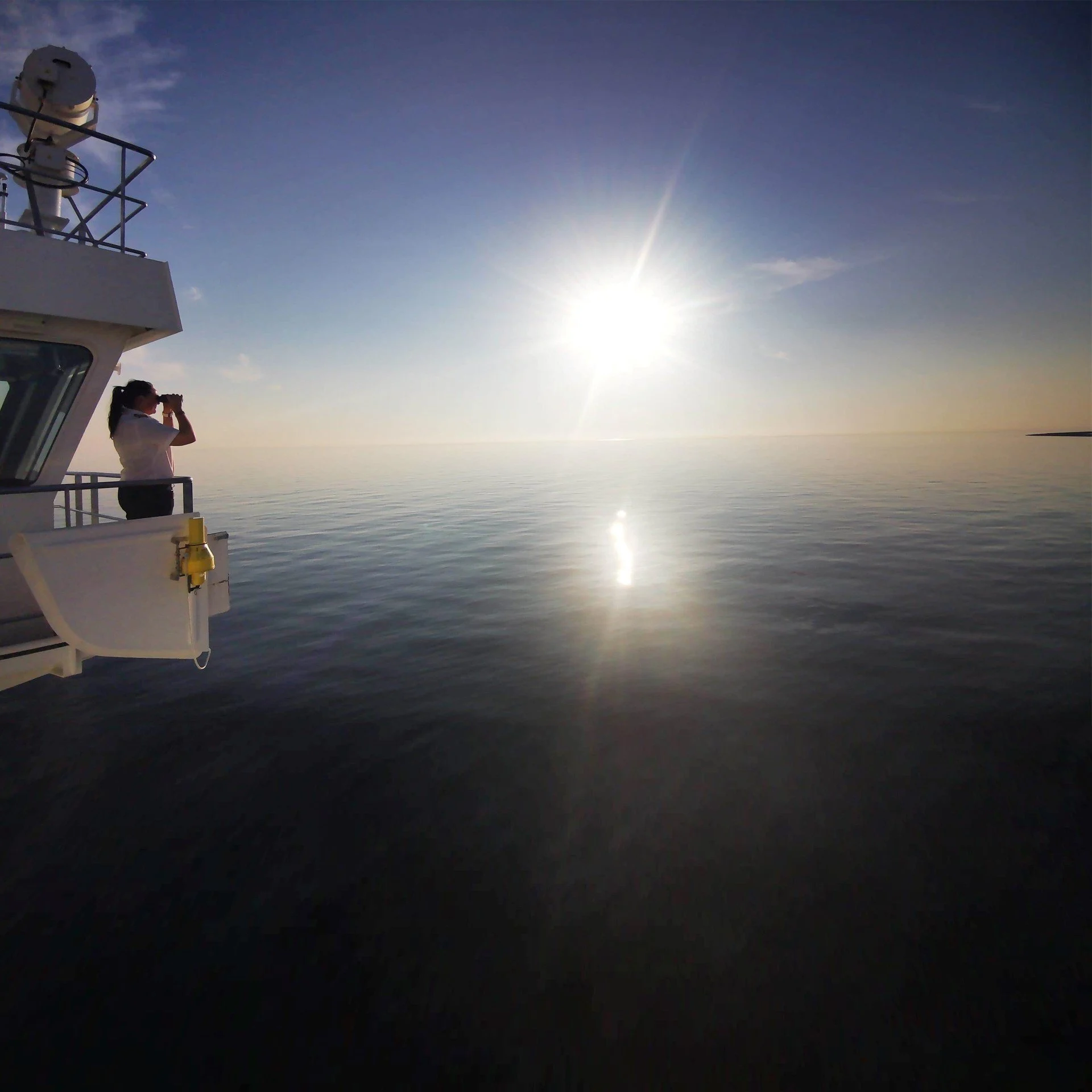 Captain Maryann Bendiksen looking at a beautiful, blue sunset