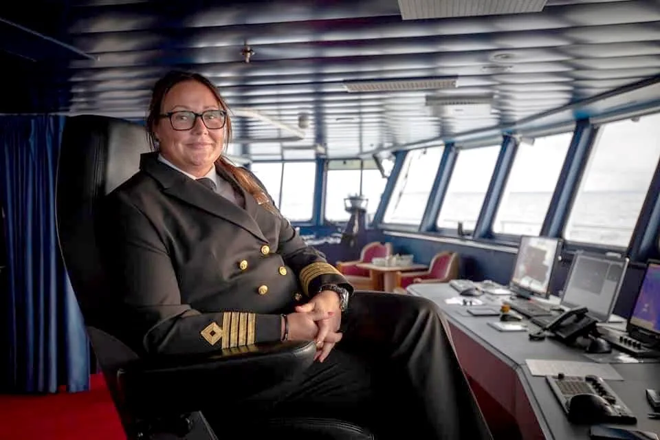 Captain Maryann Bendiksen sitting in her captains seat onboard a Hurtigruten ship