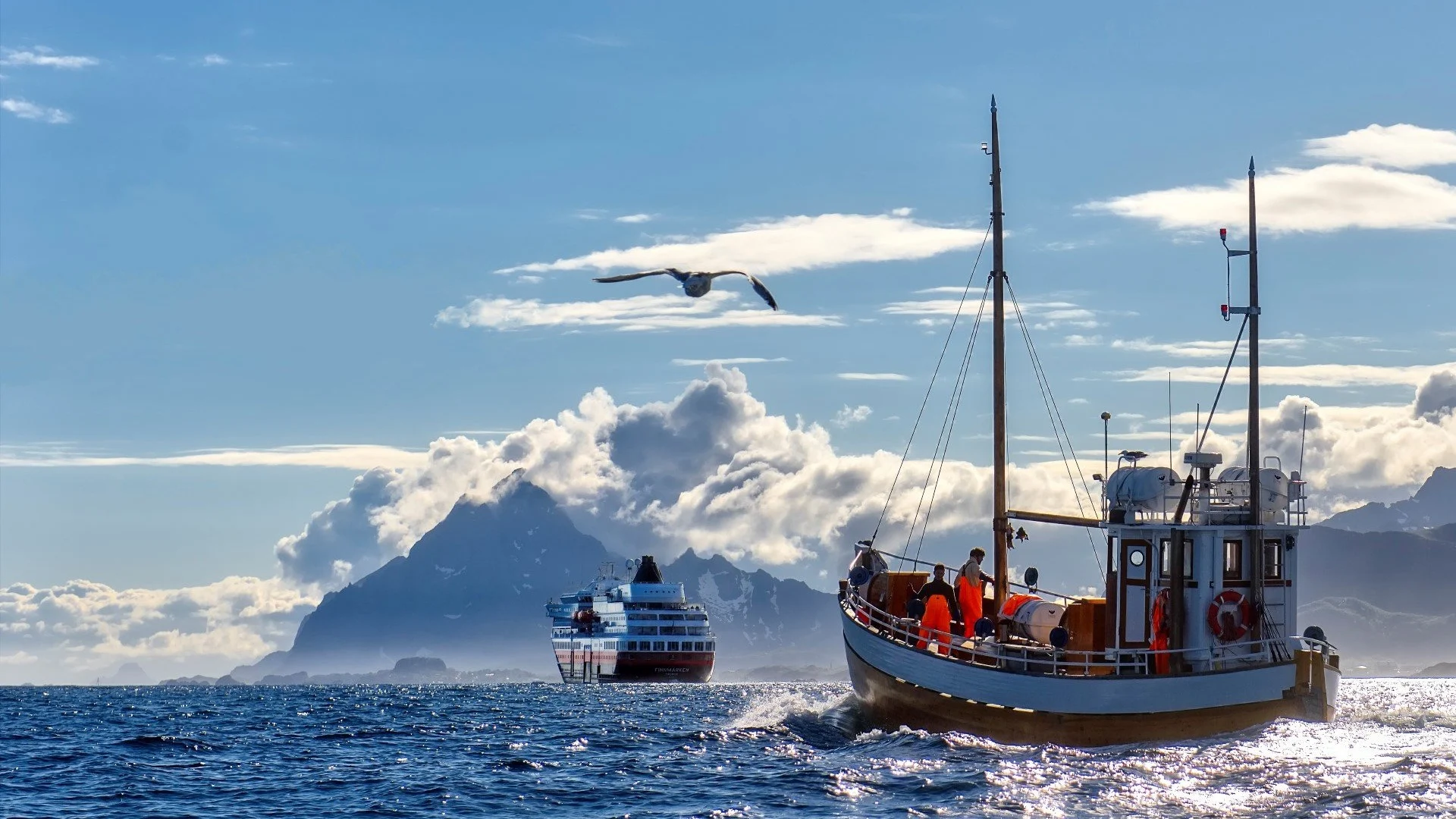 A Hurtigruten ship sailing into the horizon, with a local fishing boat behind it 