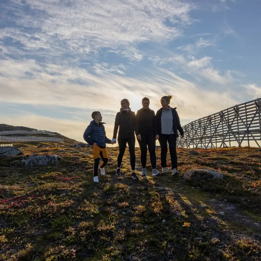 Three adults and a child on a hike in Hammerfest, Norway
