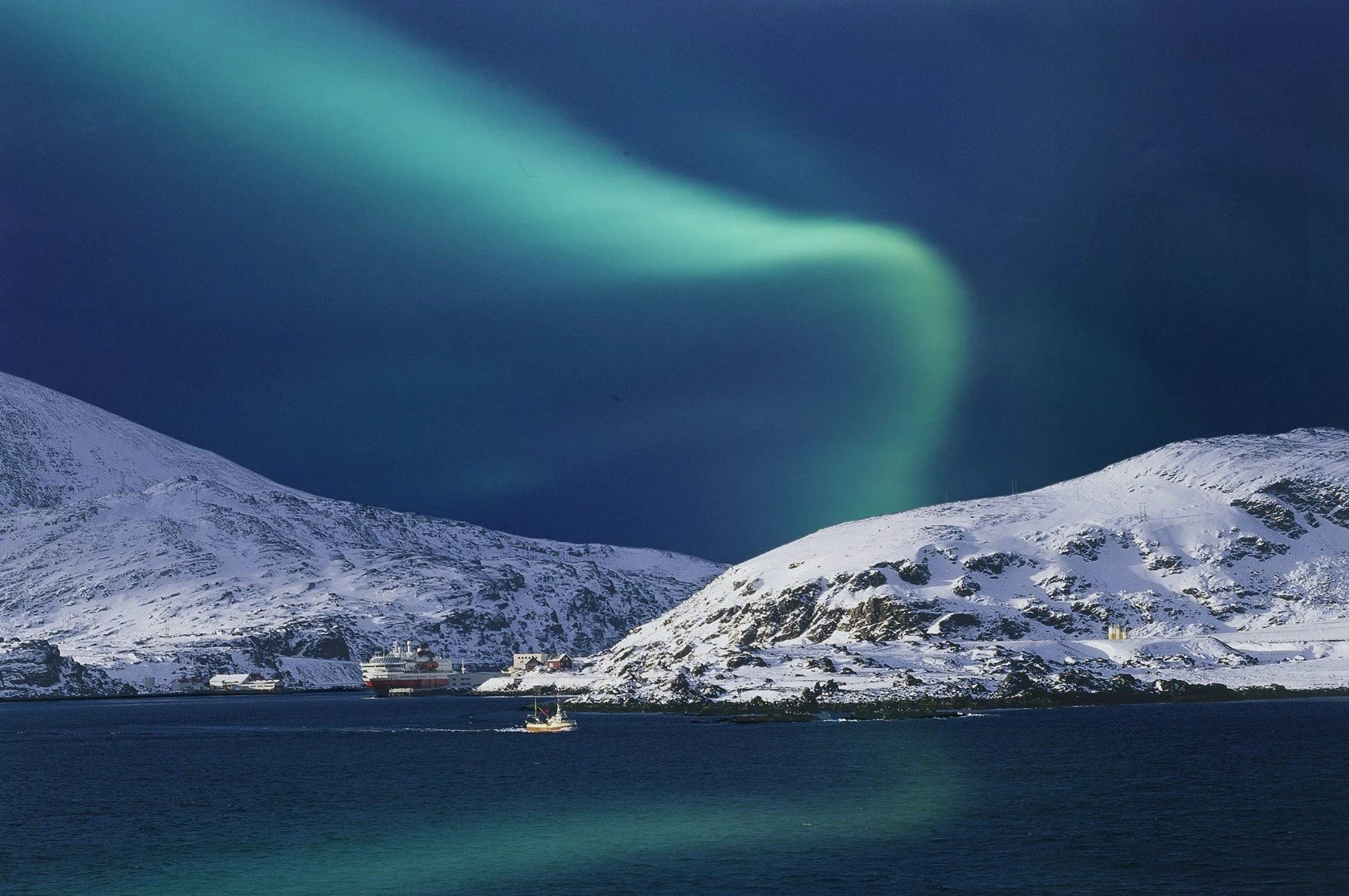 Unearthly, surreal color lights above the mountains in Northern Norway