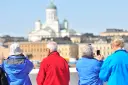 Four tourists looking at the beautiful buildings of Finlands capital, Helsinki.