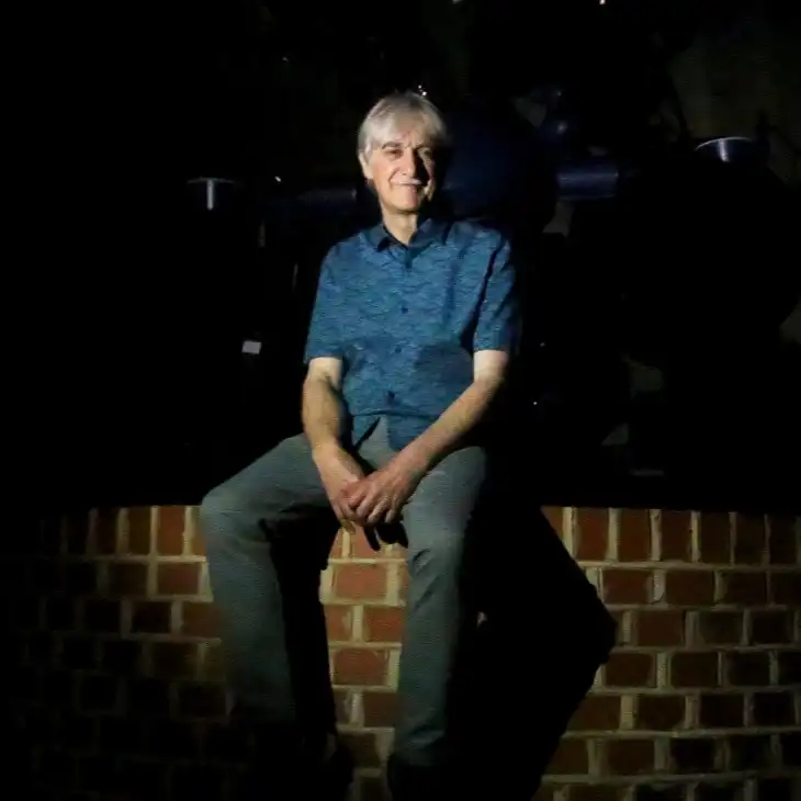 Dr John Mason sat in a Planetarium