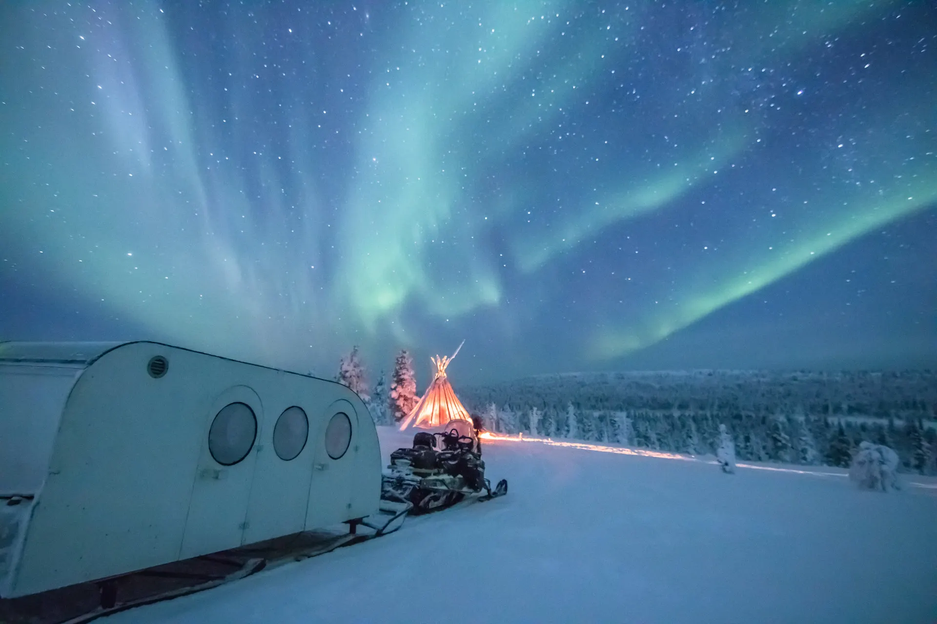 Northern lights and heated sleigh ride in snowy Arctic landscape