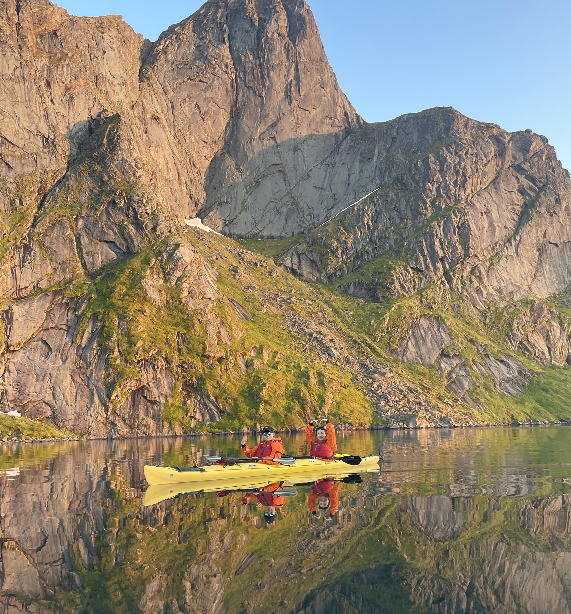 people-yellow-kayak-fjord-blue-sky-reflection