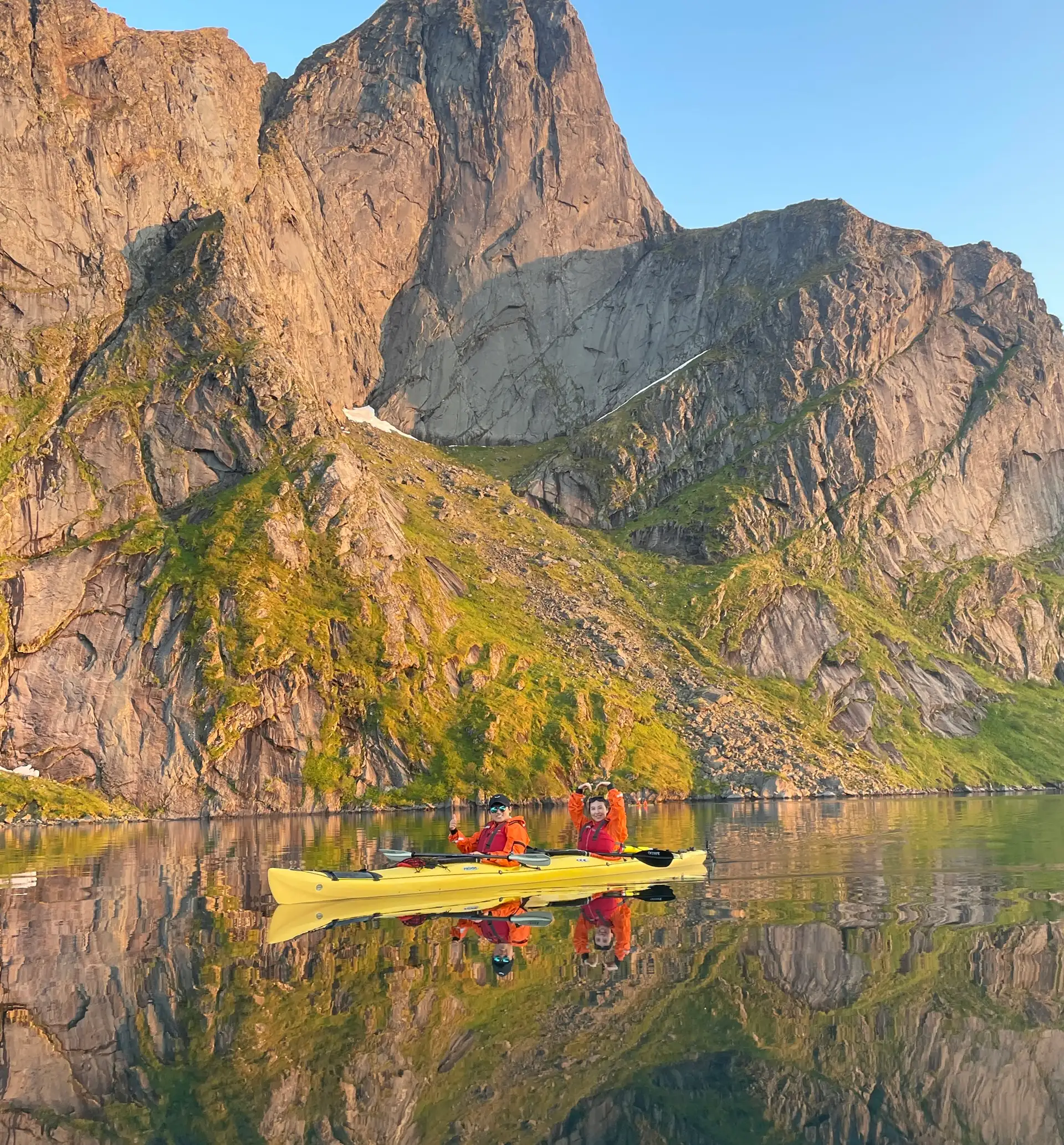 people-yellow-kayak-fjord-blue-sky-reflection