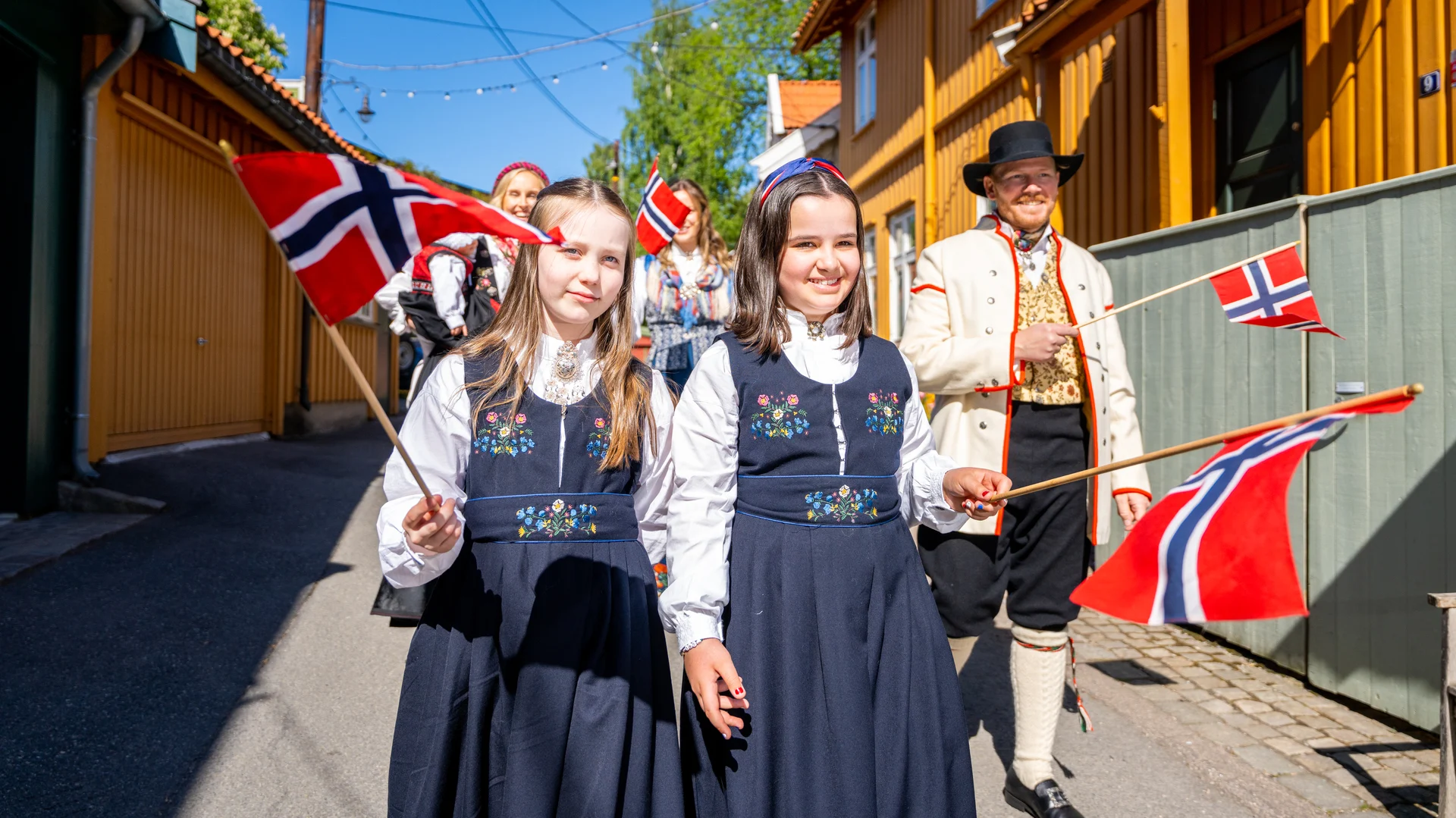 Two young girls wearing traditional bunads on Norway's Constitution Day (17 May). Image copyright: Fredrik Ahlsen/Maverix Media AS