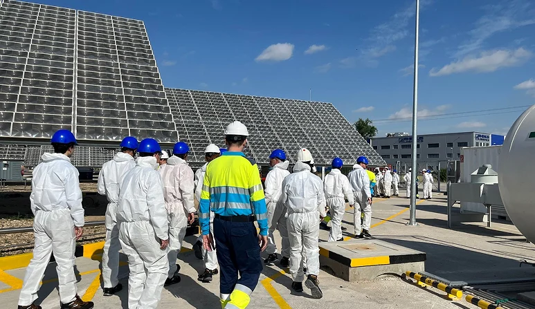 Industrial workers in jumpsuits and hard hats walking