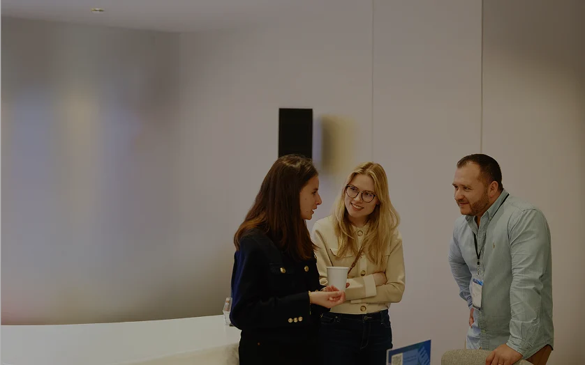 Three people standing and talking